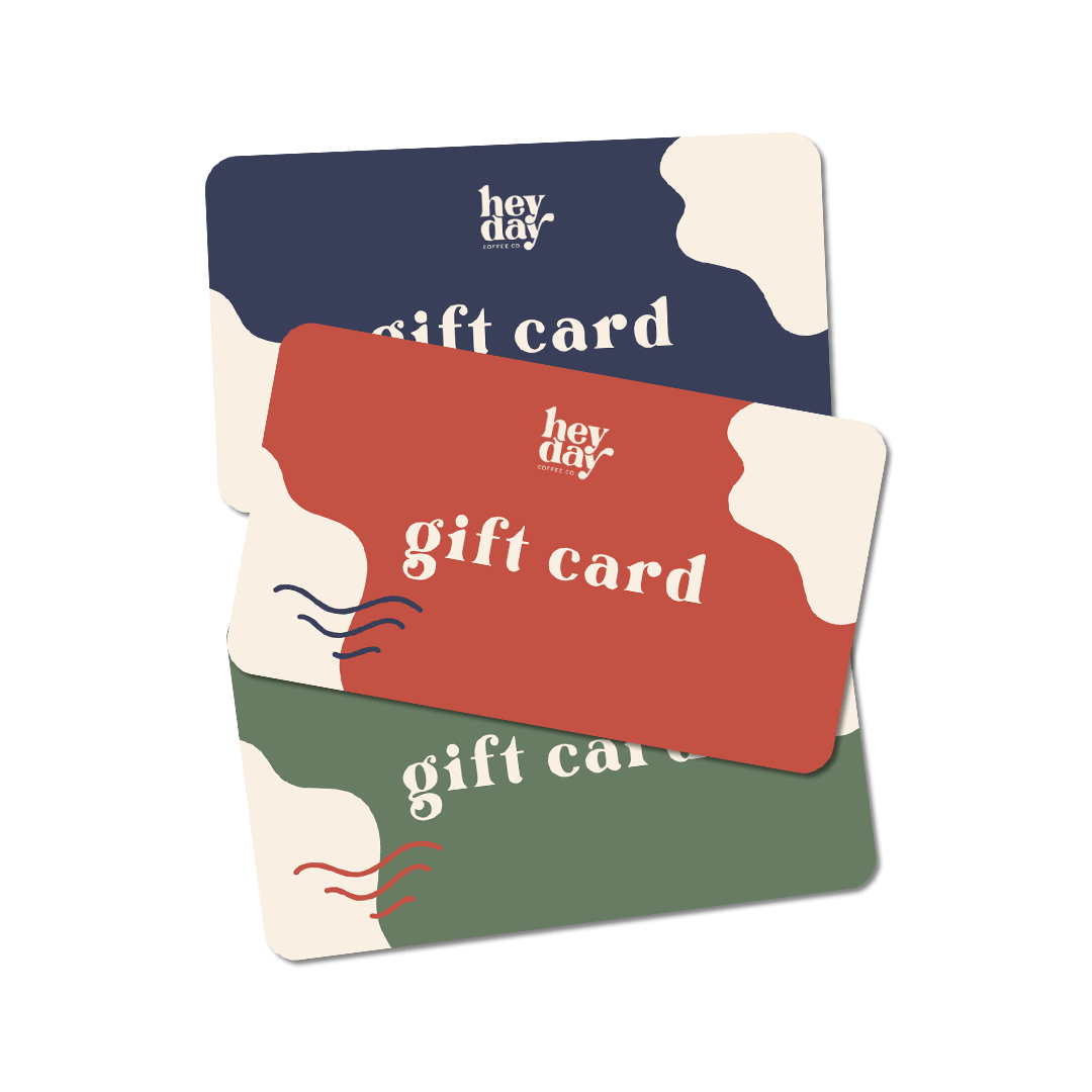 stacked gift cards in three colors.