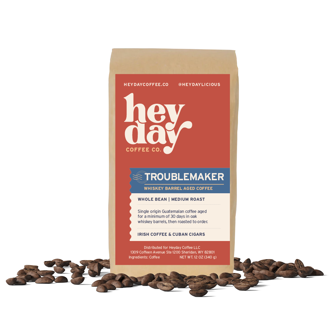 Troublemaker Whiskey Barrel Aged - Bag on Bed of Beans - Heyday Coffee Co.