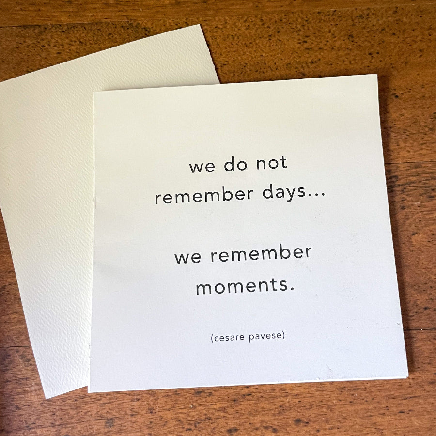 White card with printed black text on a wooden surface.